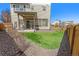 Cozy backyard with patio, synthetic grass, privacy fence, and space for outdoor seating at 18366 E 102Nd Pl, Commerce City, CO 80022
