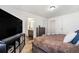 Comfortable bedroom boasts an ensuite bathroom, dark wooden furnishings, and a cozy aesthetic at 18366 E 102Nd Pl, Commerce City, CO 80022