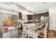Modern kitchen with dark cabinets, stainless steel appliances, and a granite island with seating at 18366 E 102Nd Pl, Commerce City, CO 80022