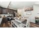 Modern kitchen featuring stainless steel appliances, granite countertops, and a large central island with seating at 18366 E 102Nd Pl, Commerce City, CO 80022