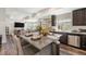 Bright, spacious kitchen with granite island, stainless appliances and an open floor plan to the Gathering room at 18366 E 102Nd Pl, Commerce City, CO 80022