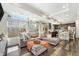 Bright, open-concept living area with a cozy sectional sofa and natural light throughout at 18366 E 102Nd Pl, Commerce City, CO 80022