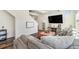 Comfortable living room with a large sectional sofa, accent pillows, and a television mounted on the wall at 18366 E 102Nd Pl, Commerce City, CO 80022