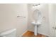 Chic powder room featuring modern fixtures, a pedestal sink, and stylish lighting at 14032 E Chenango Dr, Aurora, CO 80015