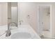 Well-lit bathroom with double sinks, a vanity, and a doorway to the walk-in closet at 14032 E Chenango Dr, Aurora, CO 80015