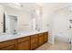Well-lit bathroom with double sinks, a vanity, and a tub-shower combo for added convenience at 14032 E Chenango Dr, Aurora, CO 80015