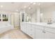 Elegant bathroom featuring double sinks, a separate shower, and a luxurious soaking tub at 14032 E Chenango Dr, Aurora, CO 80015