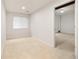 This bedroom has plush carpeting, natural light from the window, and fresh white paint at 14032 E Chenango Dr, Aurora, CO 80015