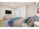 Spacious bedroom with a TV, dresser, and plush bed, providing a relaxing retreat at 14032 E Chenango Dr, Aurora, CO 80015