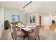 Dining room with marble table, six upholstered chairs, modern lighting and an adjacent entry at 14032 E Chenango Dr, Aurora, CO 80015