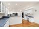 Bright kitchen with white cabinets, granite countertops, and hardwood floors at 14032 E Chenango Dr, Aurora, CO 80015