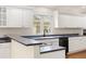 Elegant kitchen with custom cabinetry, granite countertops, and stainless steel appliances at 14032 E Chenango Dr, Aurora, CO 80015
