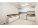 Convenient laundry room with ample counter space, storage cabinets, and modern appliances at 14032 E Chenango Dr, Aurora, CO 80015