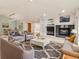 Open living room with fireplace and neutral paint with views to kitchen and entry at 14032 E Chenango Dr, Aurora, CO 80015