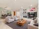 Open living room with fireplace, neutral paint and hardwood floors at 14032 E Chenango Dr, Aurora, CO 80015