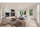 Comfortable living room featuring a fireplace, built-in shelving, and large windows with natural light at 14032 E Chenango Dr, Aurora, CO 80015