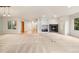 Bright living room with fireplace, built-ins, and large windows for natural light at 14032 E Chenango Dr, Aurora, CO 80015