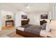 Large main bedroom with hardwood accents, ensuite entrance, and dual dressers at 14032 E Chenango Dr, Aurora, CO 80015