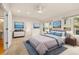 Spacious main bedroom featuring neutral decor, natural light, and ensuite bathroom access at 14032 E Chenango Dr, Aurora, CO 80015