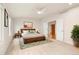 Spacious main bedroom with hardwood accents, multiple windows, ceiling fan, and ensuite entrance at 14032 E Chenango Dr, Aurora, CO 80015