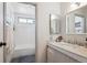 Bright bathroom featuring a marble countertop, subway tile shower, and modern fixtures at 16046 E Ithaca Pl # C, Aurora, CO 80013