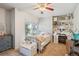 Bright bedroom featuring a window with outside views, white furniture, and charming decor at 16046 E Ithaca Pl # C, Aurora, CO 80013