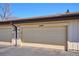 Garage exterior featuring a large garage door with address number and driveway at 16046 E Ithaca Pl # C, Aurora, CO 80013