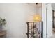 Upstairs hallway featuring a woven light fixture and framed art on the wall along the railing at 16046 E Ithaca Pl # C, Aurora, CO 80013