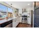 Bright kitchen featuring white cabinetry, butcher block countertops, and stainless steel appliances at 16046 E Ithaca Pl # C, Aurora, CO 80013