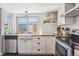 Bright kitchen featuring white cabinetry, butcher block countertops, and stainless steel appliances at 16046 E Ithaca Pl # C, Aurora, CO 80013
