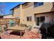 Backyard brick patio featuring an outdoor table and space for gardening, perfect for relaxation and entertaining at 16046 E Ithaca Pl # C, Aurora, CO 80013