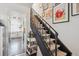 Unique staircase with striped treads and gallery wall creates an inviting transition between floors at 16046 E Ithaca Pl # C, Aurora, CO 80013