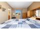 Bedroom with light-colored walls and a large window overlooking a well-maintained front yard at 3695 S Kittredge St # D, Aurora, CO 80013