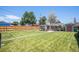 Expansive backyard featuring a lush lawn, wooden fence, and versatile outdoor spaces at 2465 W Mosier Pl, Denver, CO 80223