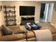 Finished basement featuring a comfortable seating area with a flat-screen TV and modern shelving at 2465 W Mosier Pl, Denver, CO 80223