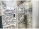 Modern bathroom featuring unique city-themed wall art, a glass-enclosed shower, and stylish tile flooring at 2465 W Mosier Pl, Denver, CO 80223