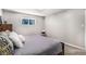 Comfortable bedroom with neutral colors, a cozy bed, and a bright window at 2465 W Mosier Pl, Denver, CO 80223