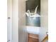 Hallway with a stylish origami painting and a staircase leading to the basement, providing a unique artistic touch at 2465 W Mosier Pl, Denver, CO 80223