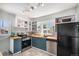 Well-lit kitchen featuring butcher block countertops and stainless steel appliances at 2465 W Mosier Pl, Denver, CO 80223