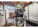 Basement laundry area featuring a stackable washer and dryer, with utility sink at 2465 W Mosier Pl, Denver, CO 80223