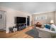 Cozy living room with hardwood floors, plush seating, and ample natural light at 2465 W Mosier Pl, Denver, CO 80223