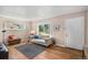 Inviting living room with stylish decor, hardwood floors, and plenty of natural light at 2465 W Mosier Pl, Denver, CO 80223