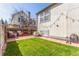 Spacious backyard with a brick patio, green lawn, a privacy fence, and a view of the home's exterior at 3082 W 107Th Pl # H, Westminster, CO 80031