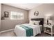Bedroom featuring a comfortable bed, a window, and a stylish side table with decor at 3082 W 107Th Pl # H, Westminster, CO 80031