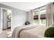 Bedroom with ensuite bathroom, large windows, neutral colors, and a comfortable chair at 3082 W 107Th Pl # H, Westminster, CO 80031