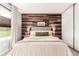 Bedroom with wooden accent wall and coordinated bedside tables and lamps at 3082 W 107Th Pl # H, Westminster, CO 80031
