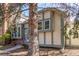 Home exterior featuring brick detailing, large windows, well-kept landscaping, and welcoming front entry framed by mature tree at 3082 W 107Th Pl # H, Westminster, CO 80031