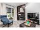 Cozy living room features a fireplace, a comfortable chair, and large window at 3082 W 107Th Pl # H, Westminster, CO 80031