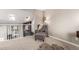 Cozy living room with plush armchair, decorative floor lamp, and view of the upstairs balcony at 3082 W 107Th Pl # H, Westminster, CO 80031