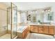 Bright bathroom featuring double sinks, a soaking tub, and walk-in shower at 3532 Springbriar Dr, Castle Rock, CO 80109